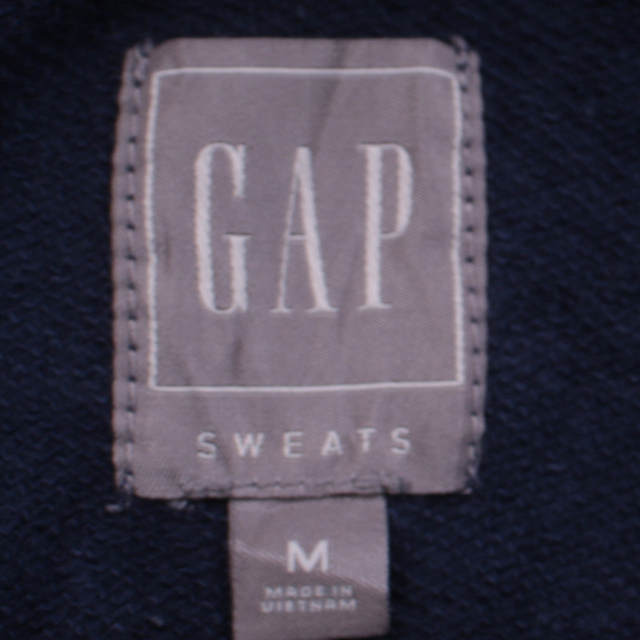 Brand and care label for Gap Men's Blue Pullover Hoodie Medium Fleece Sweatshirt
