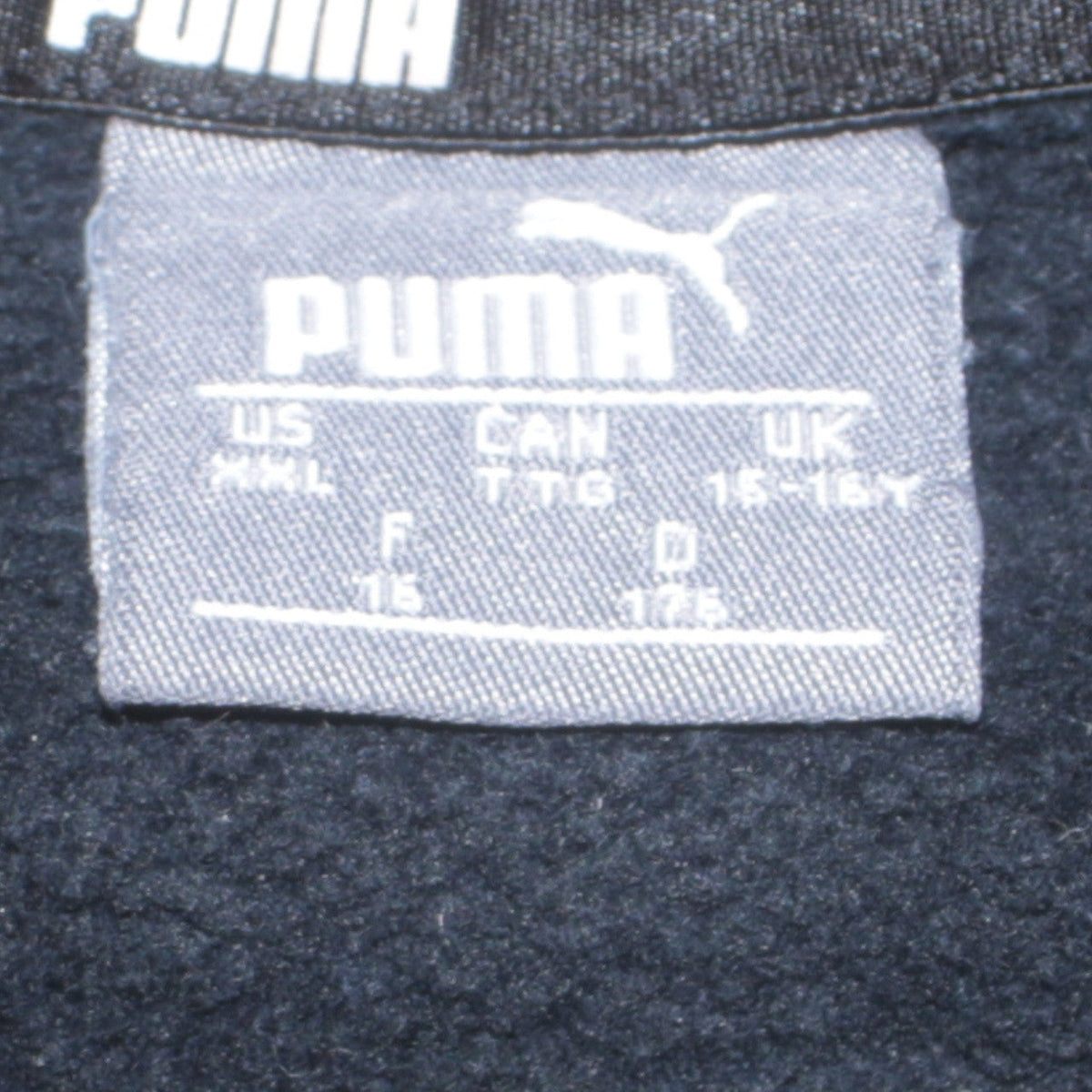 Close-up detail of Puma boys’ black pullover sweatshirt 15-16 years fleece logo crew neck