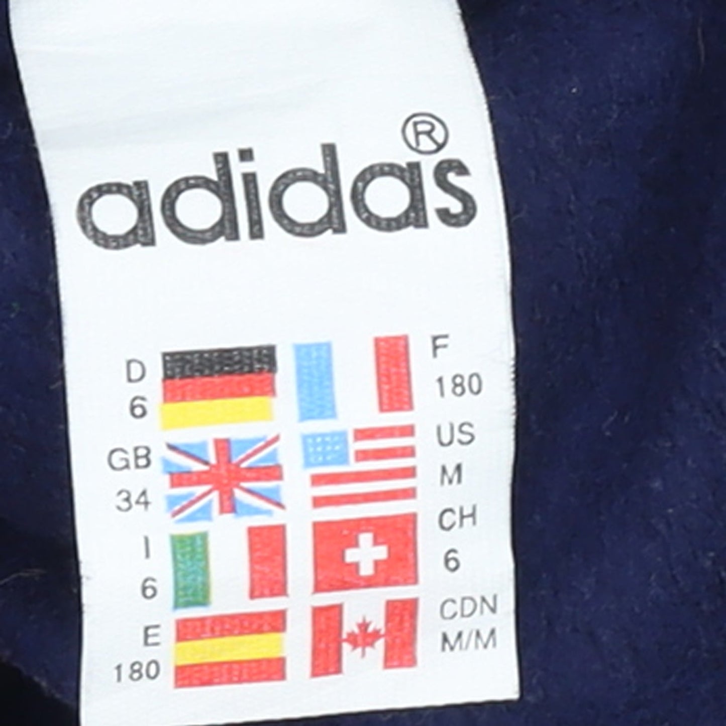 Brand and care label for Adidas women’s blue sweatpants, size UK 8, tapered fleece loungewear