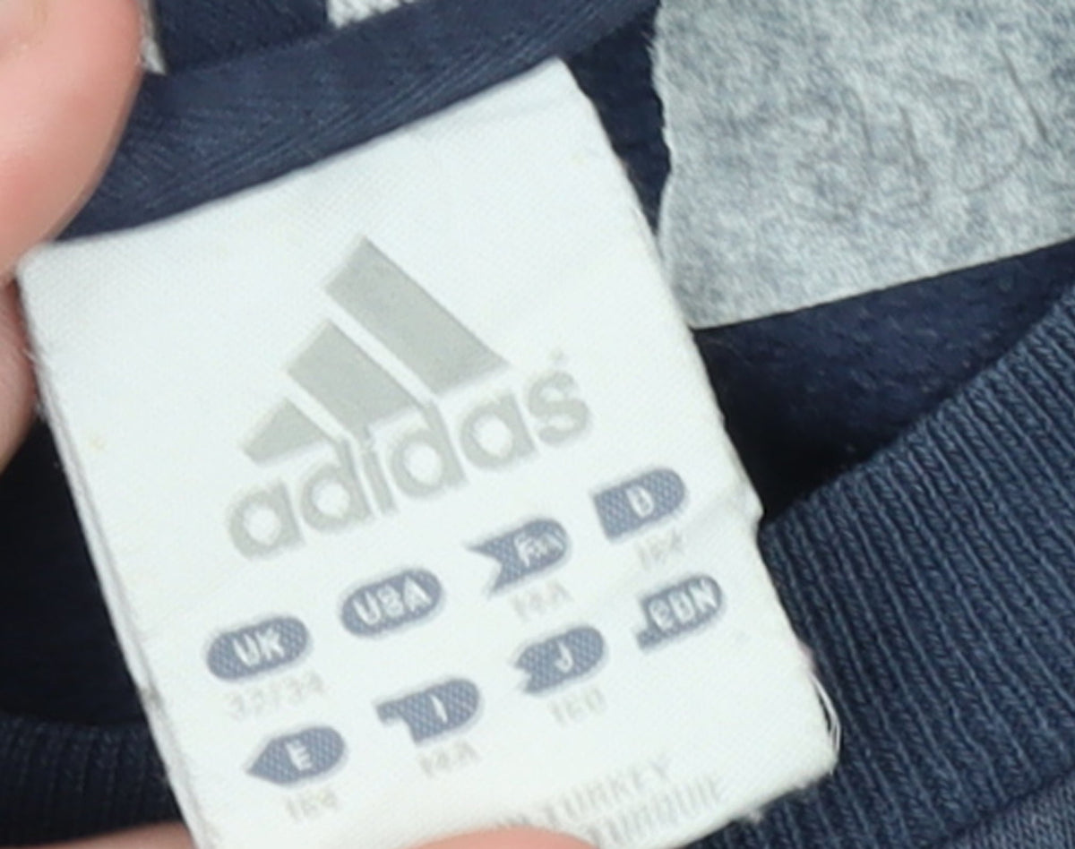Brand and care label for Adidas boys’ navy blue crew neck sweatshirt, size 12-13, years casual
