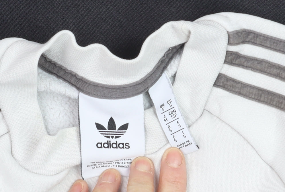 Brand and care label for Adidas men’s grey crew neck jumper, size S, sports fleece