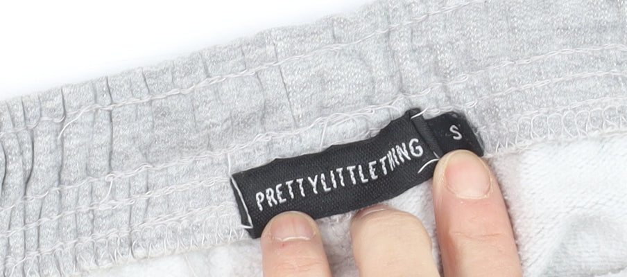 Brand and care label for PRETTYLITTLETHING girls’ grey jogger trousers s elastic waist fleece