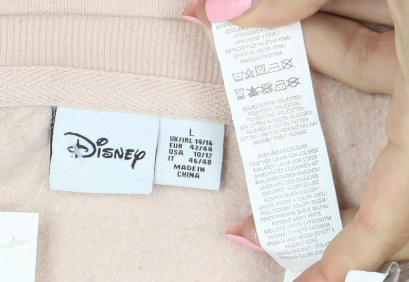 Brand and care label for Disney Women Beige Minnie Mouse Pullover Sweatshirt, size 16 L