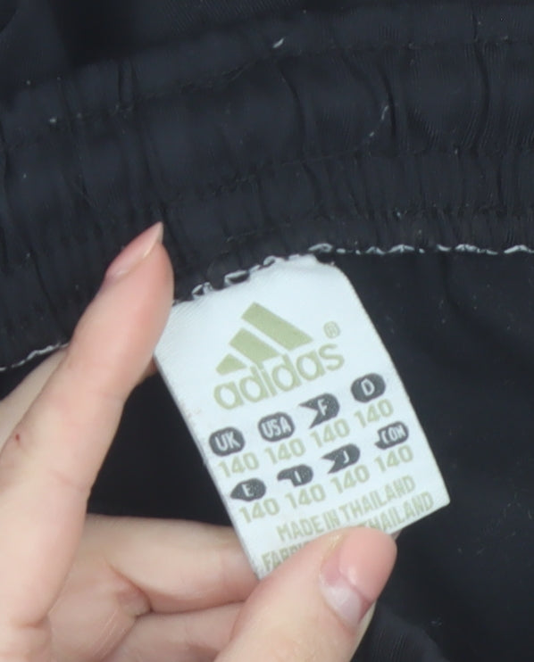 Brand and care label for Adidas boys’ black manchester united joggers 14 years football activewear