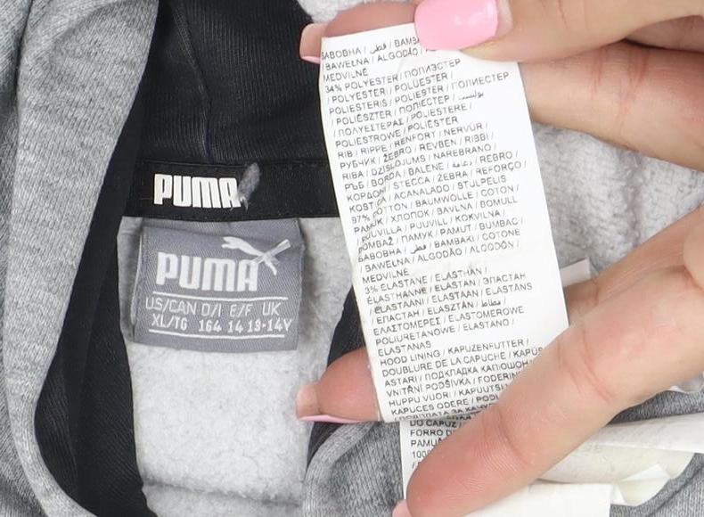Brand and care label for Puma boys’ grey pullover hoodie, size 14-15, years cotton blend