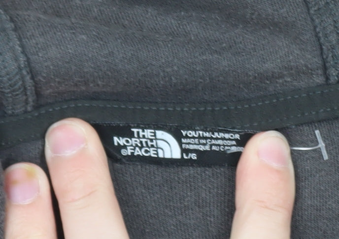 Brand and care label for The North Face boys’ black fleece full zip hoodie, size L, outdoor warm