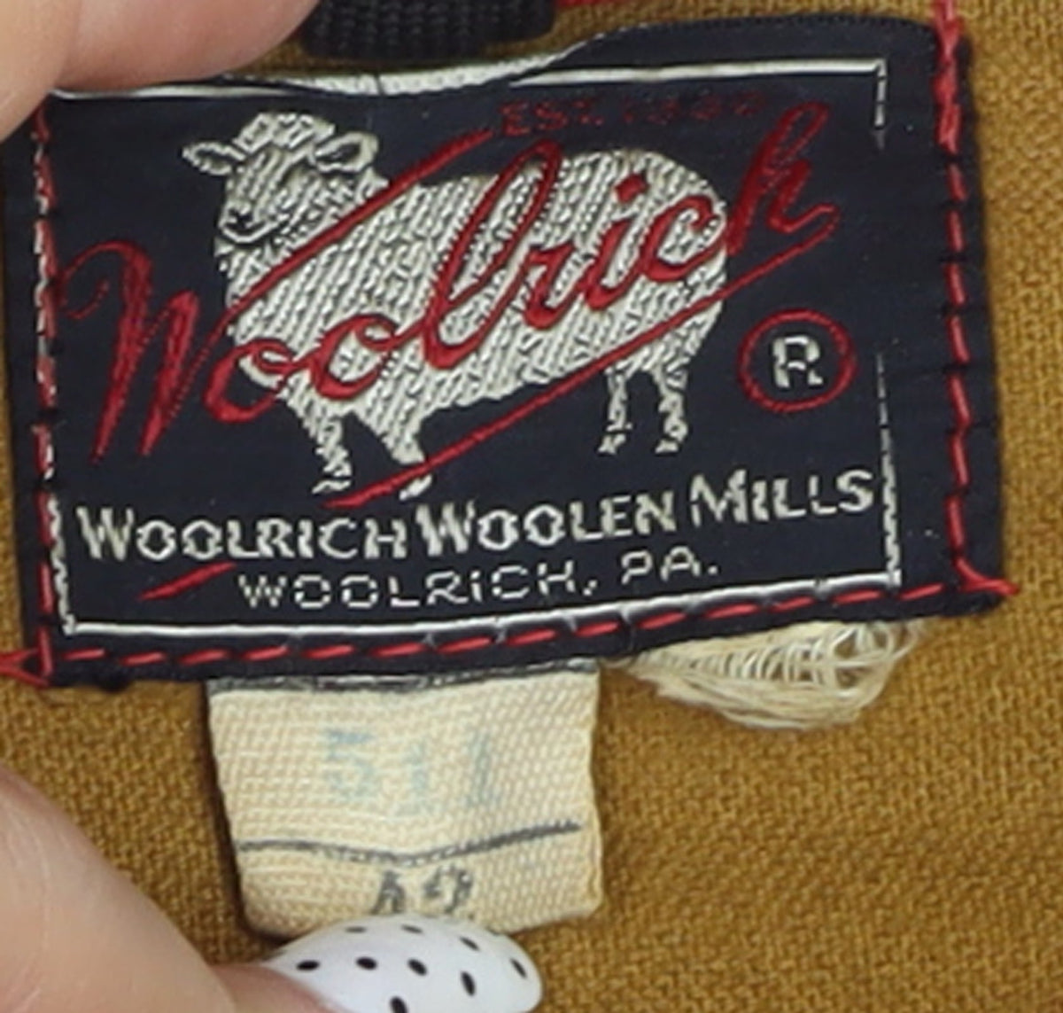 Brand and care label for Woolrich Women's Red Wool Lined Mid-Length Parka Coat M