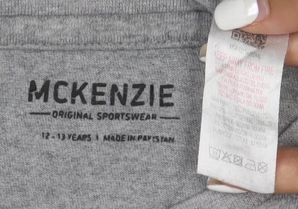 Brand and care label for McKenzie girls’ grey short sleeve crew neck cotton t-shirt 12-13 years