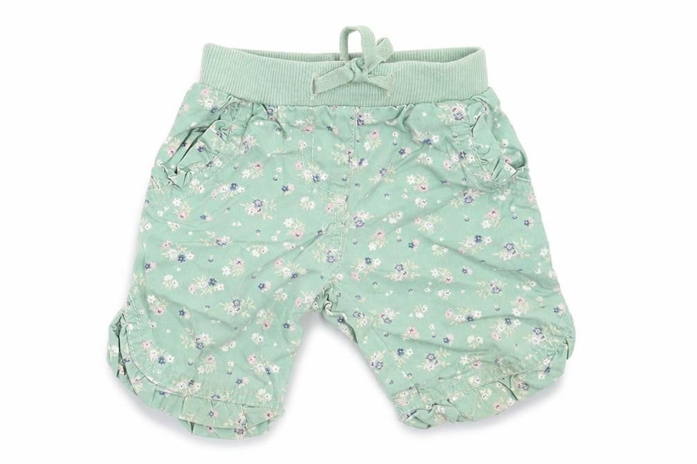 Front view of Next girls’ green floral cropped trousers, size 3-6, months