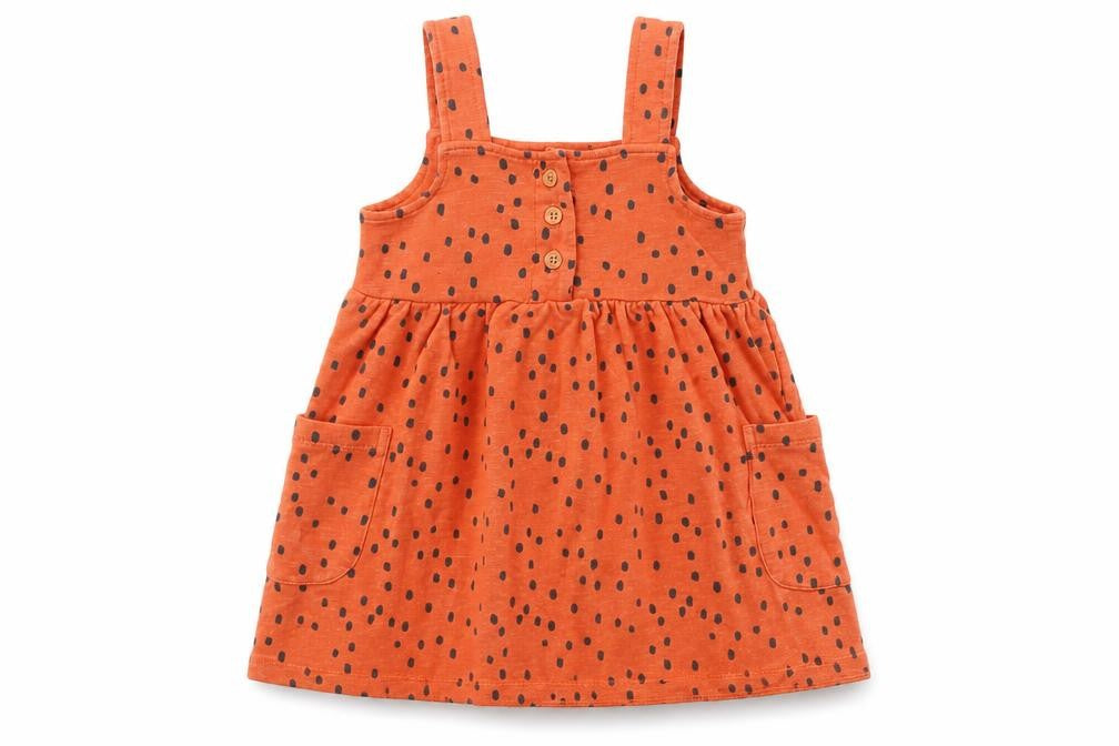 Front view of Nutmeg boys’ orange spotted pinafore/dungaree dress, size 12-18, months