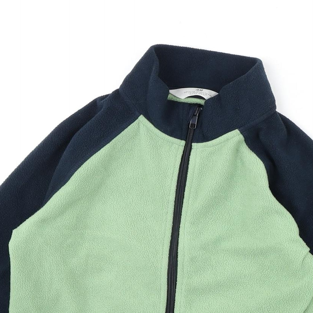 Close-up detail of H&M boys’ green jacket, size 6-7, years zip -, size 6-8