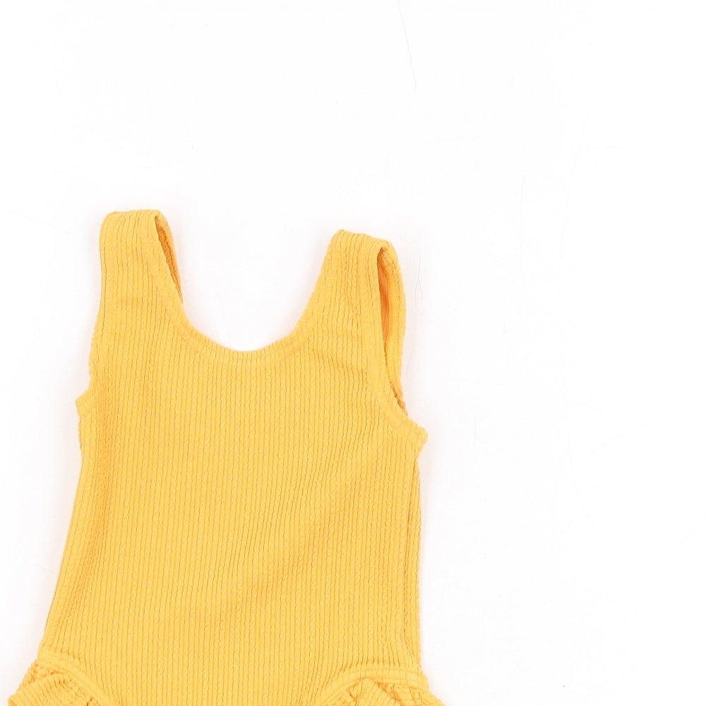 Close-up detail of Marks & Spencer girls’ orange polyester unitard one-piece, size 0-3, months pullover