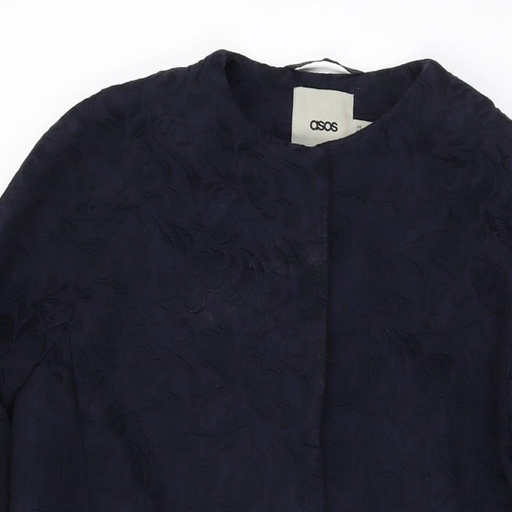 Close-up detail of ASOS women’s blue floral overcoat coat, size UK 6, snap