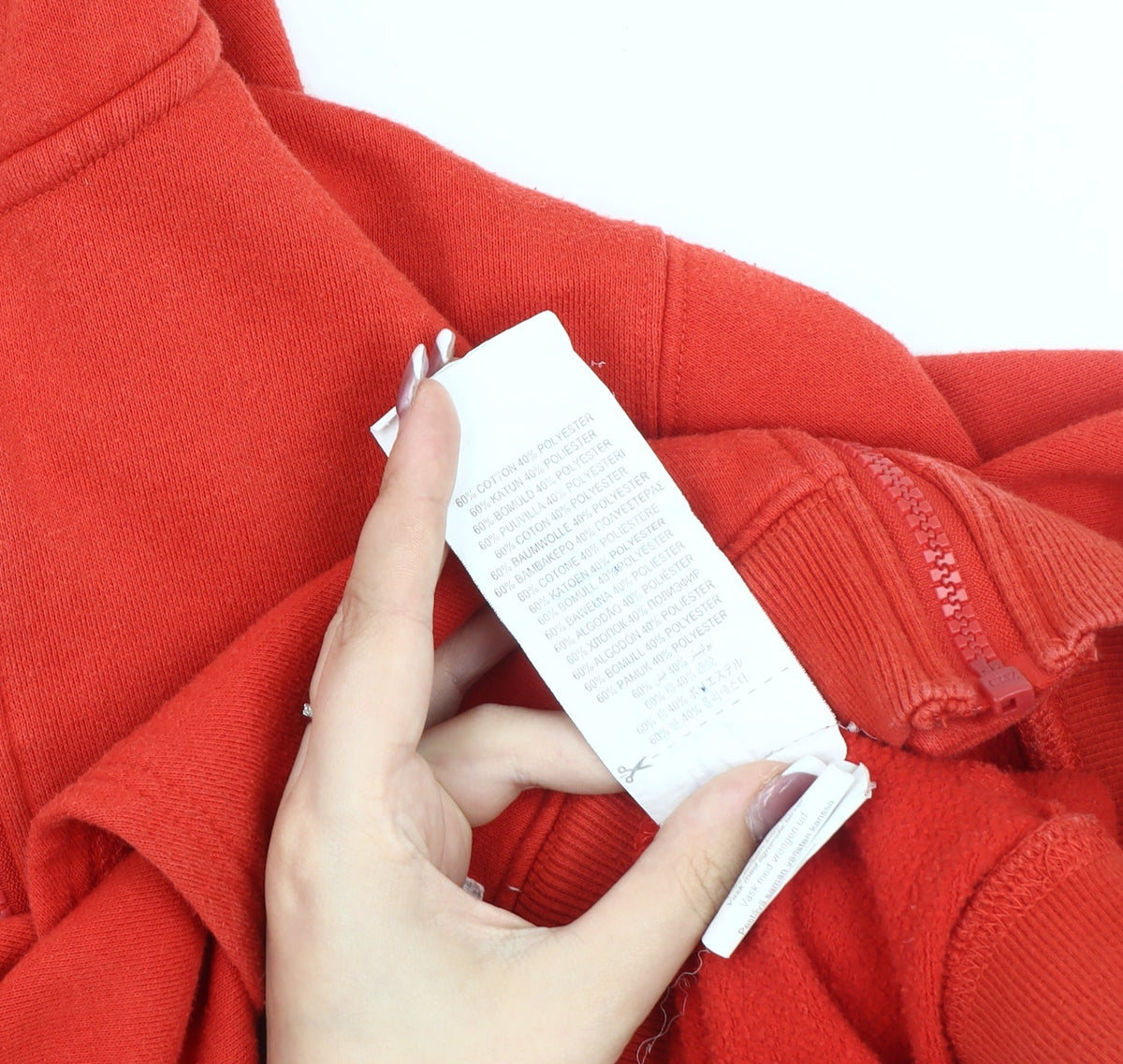 Brand and care label for Original Penguin boys’ red hoodie jacket 12-13 years