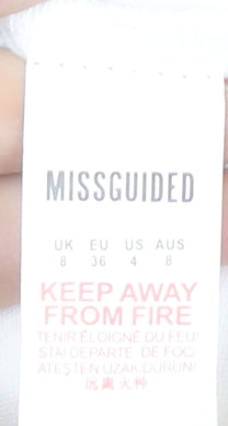 Close-up detail of Missguided women’s ivory short sheath dress, size UK 8