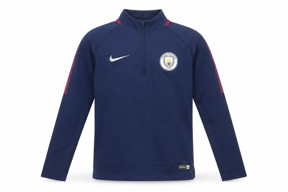 Front view of Nike boys’ blue manchester city dri-fit 1/4 zip football track jacket 10-12 years