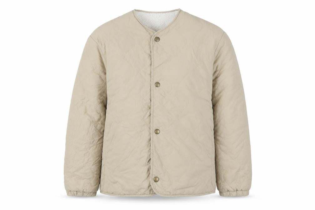 Front view of Uniqlo girls’ beige quilted mid-length jacket, size 11-12, years