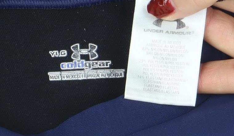 Brand and care label for Under Armour boys’ blue long sleeve coldgear athletic pullover top, size L