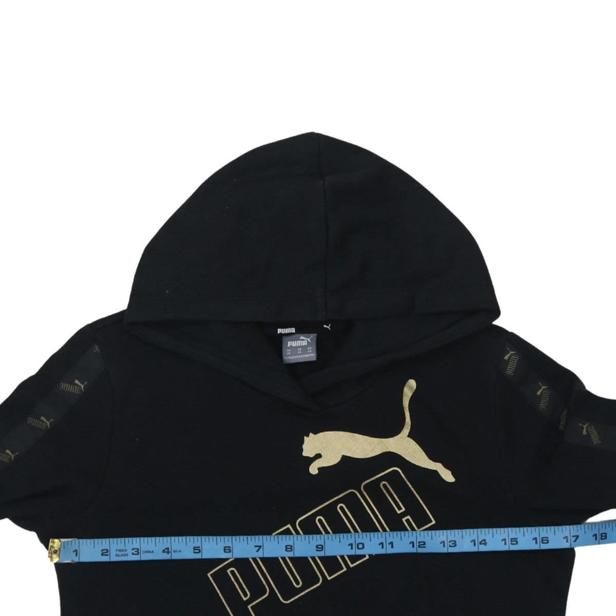 Close-up detail of Puma Men's Black XS Pullover Hoodie with Gold Logo