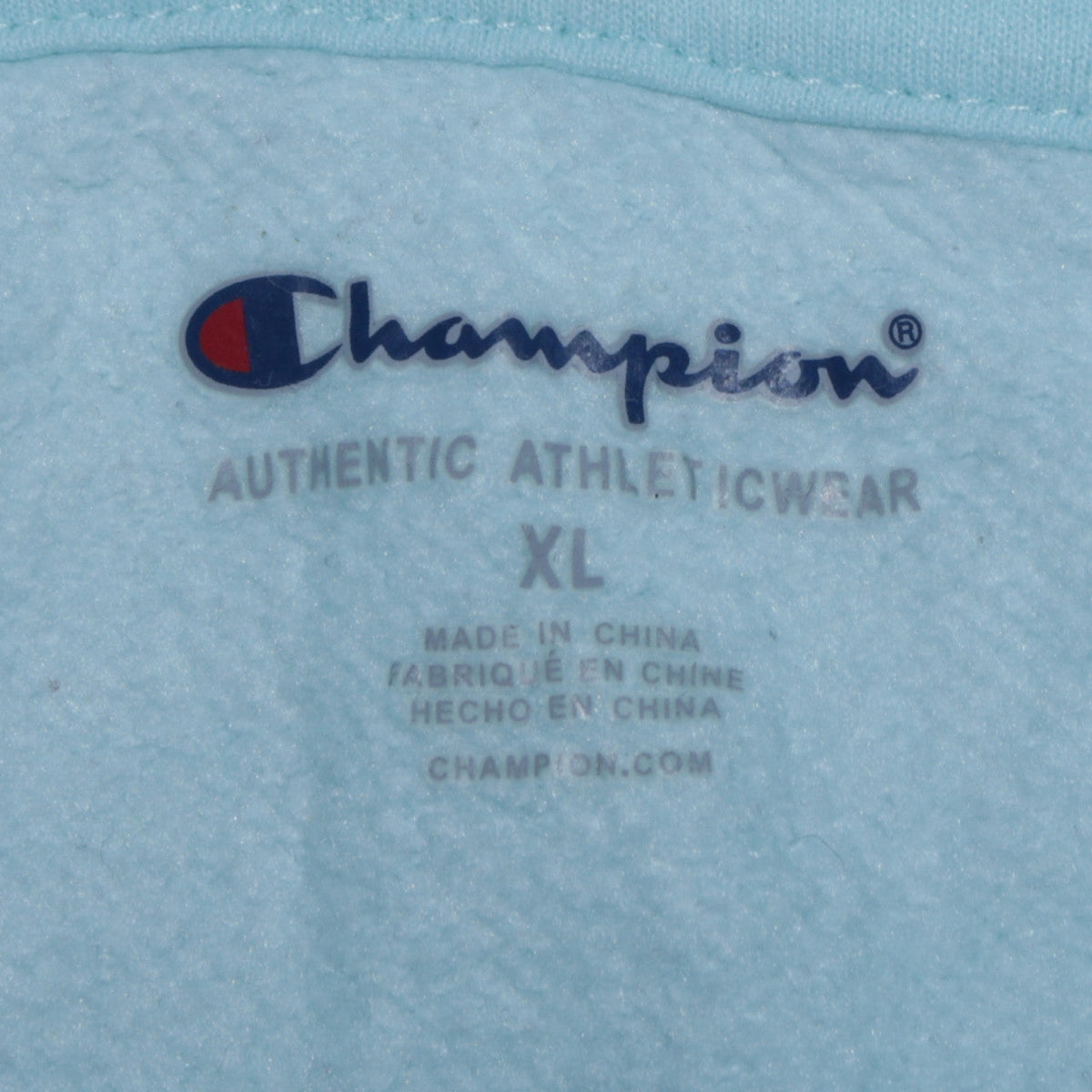 Close-up detail of Champion boys’ blue xl pullover hoodie with logo embroidery