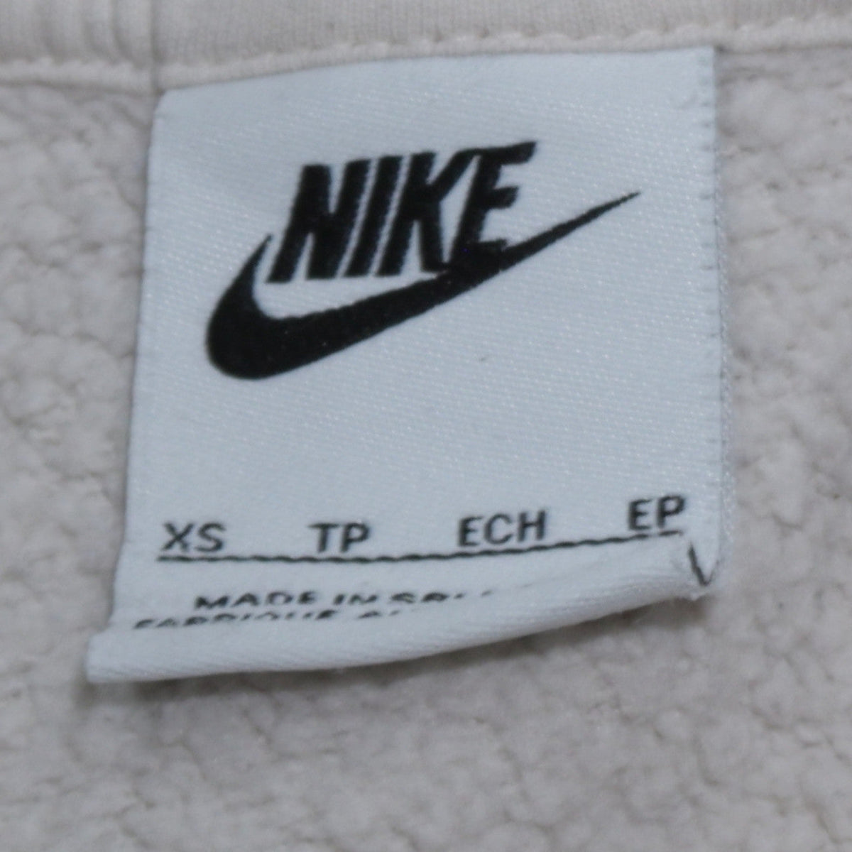 Brand and care label for Nike Women's Beige XS Pullover Hoodie 80% Cotton Logo Print