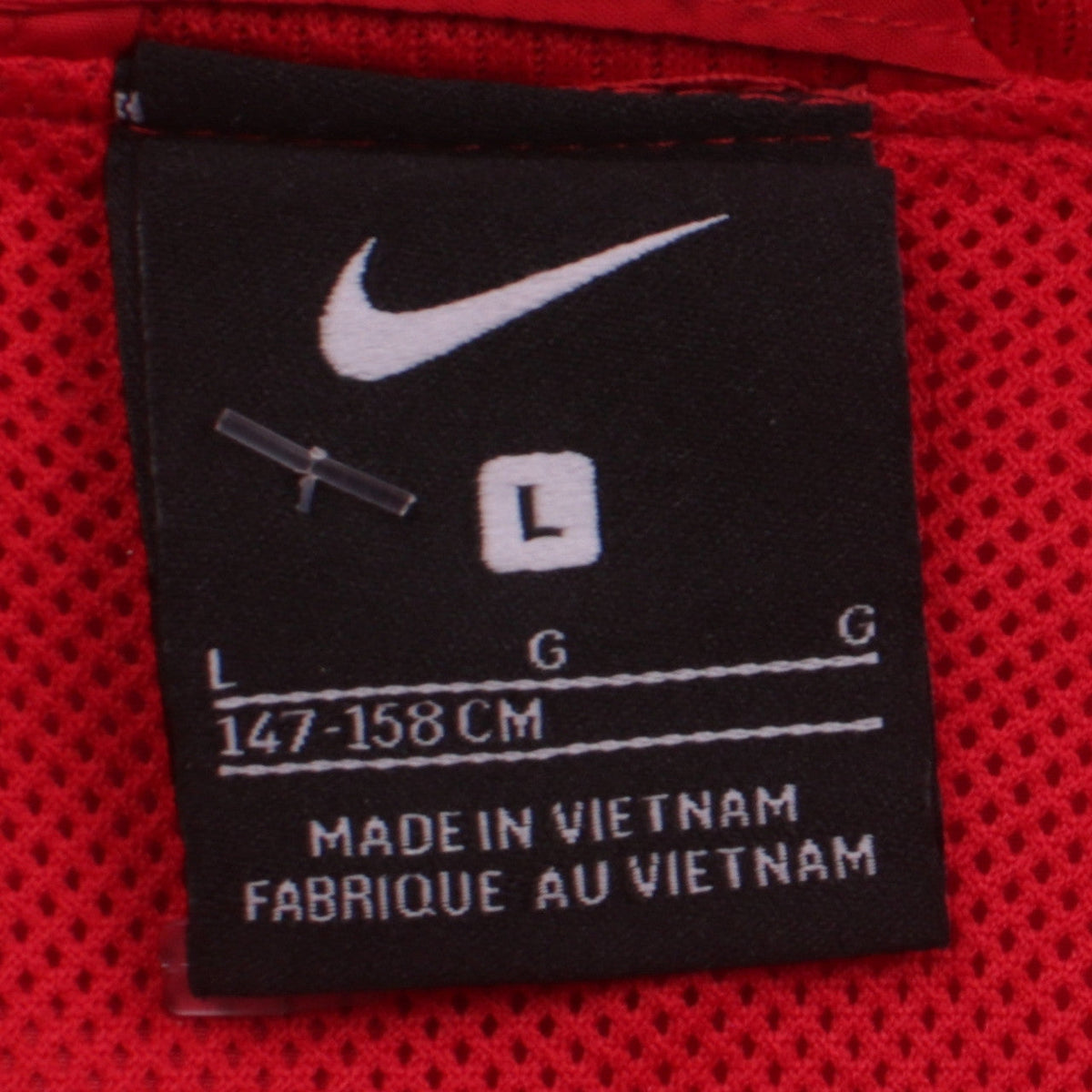 Close-up detail of Nike boys’ red football track jacket, size L, 147-158cm full zip lightweight