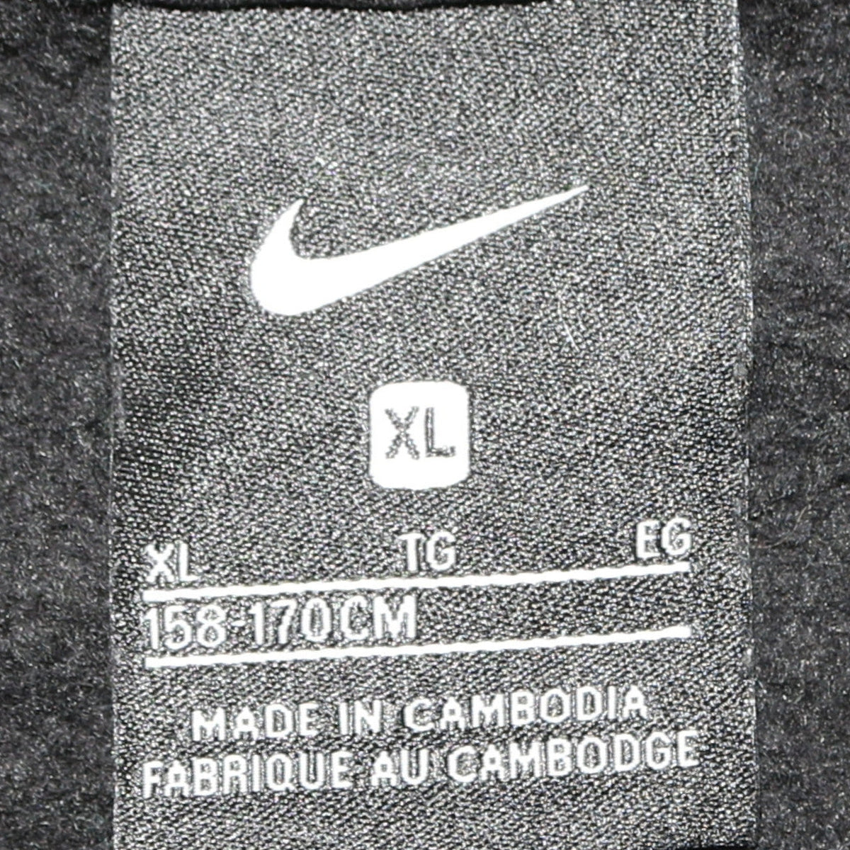 Close-up detail of Nike boys’ black full zip hoodie xl 158-170cm with logo and pocket