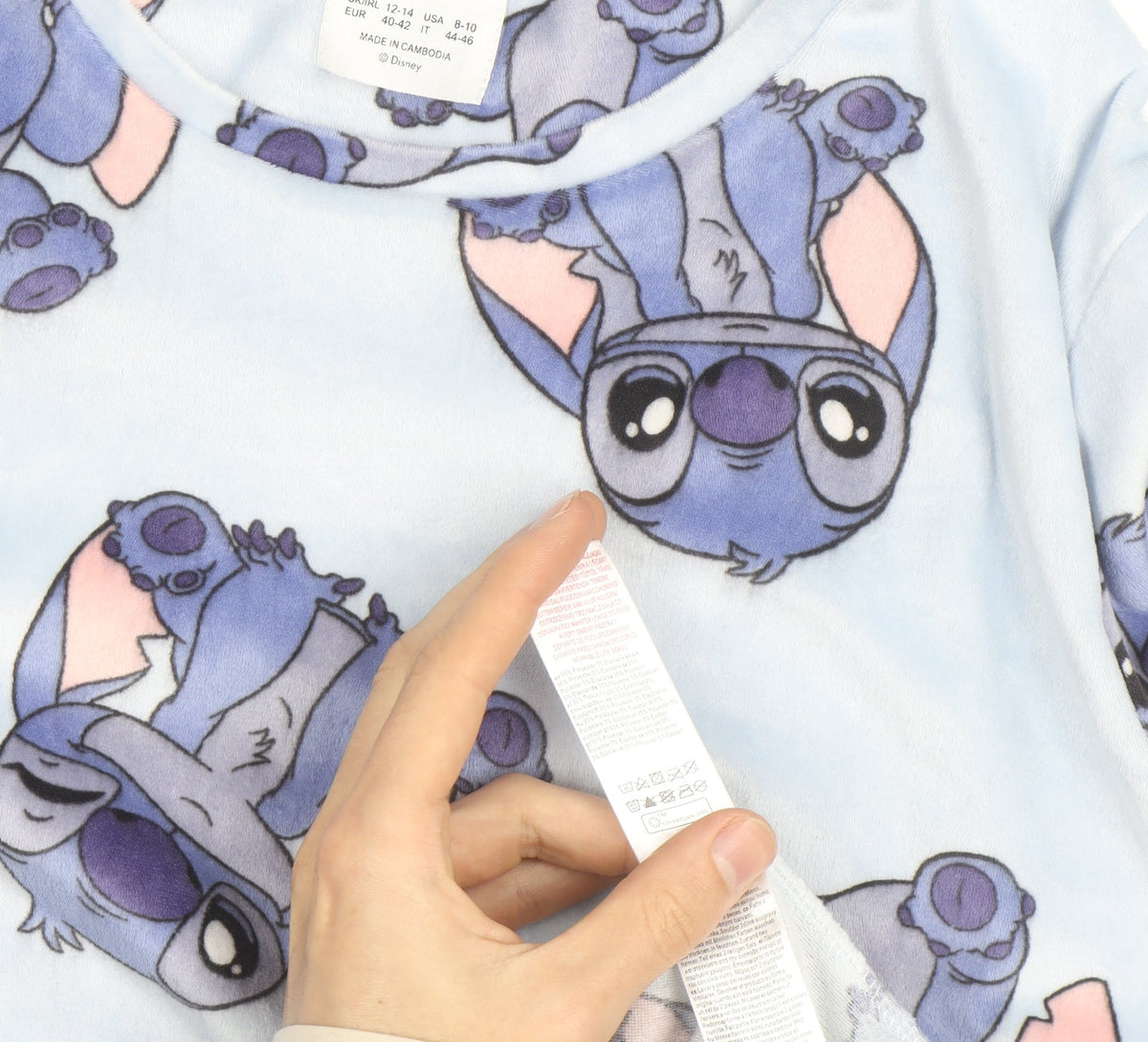 Brand and care label for Disney girls’ blue stitch jumper medium uk 12-14 pullover fleece