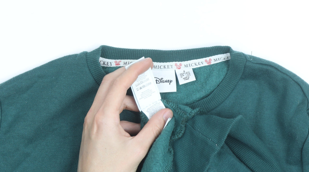Brand and care label for Disney Men's Green Mickey Mouse Graphic Pullover Sweatshirt, size S