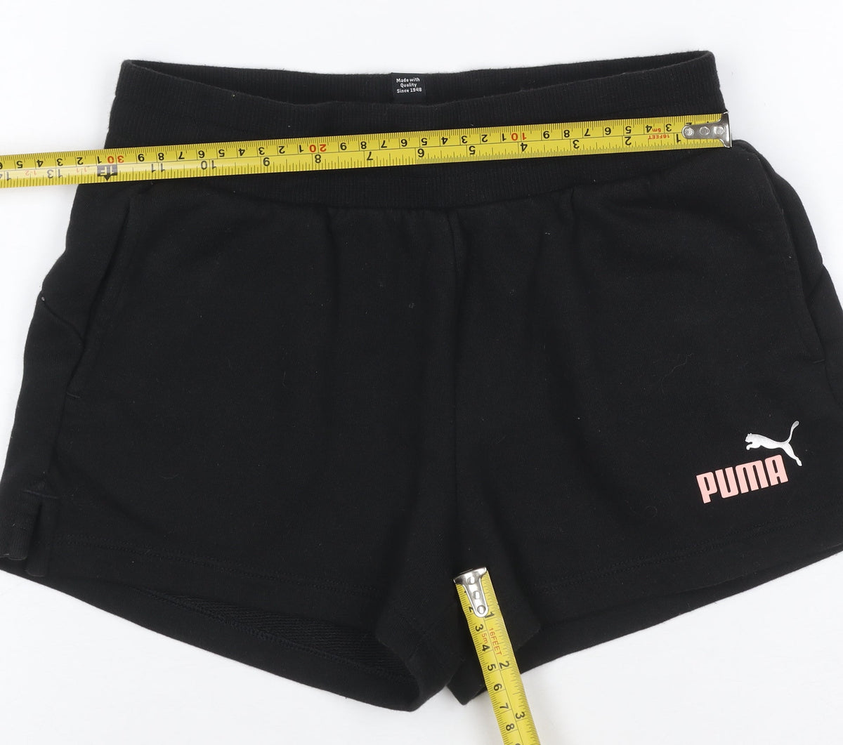 Brand and care label for Puma girls’ black pink logo athletic jersey shorts uk 10 years