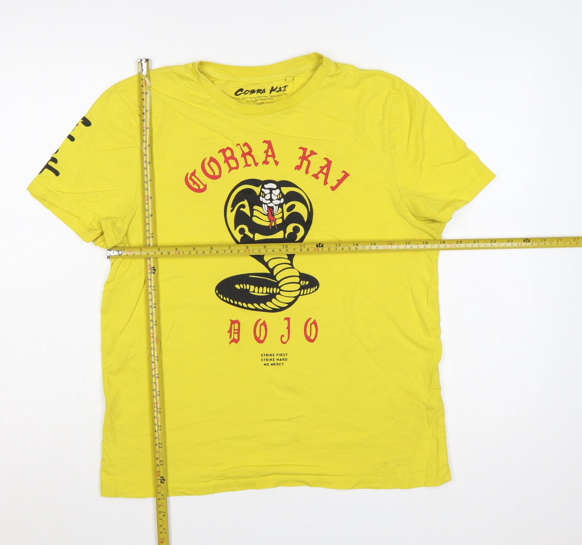 Close-up detail of Cobra Kai Men’s Yellow S Graphic Logo Short Sleeve Crew Neck T-Shirt