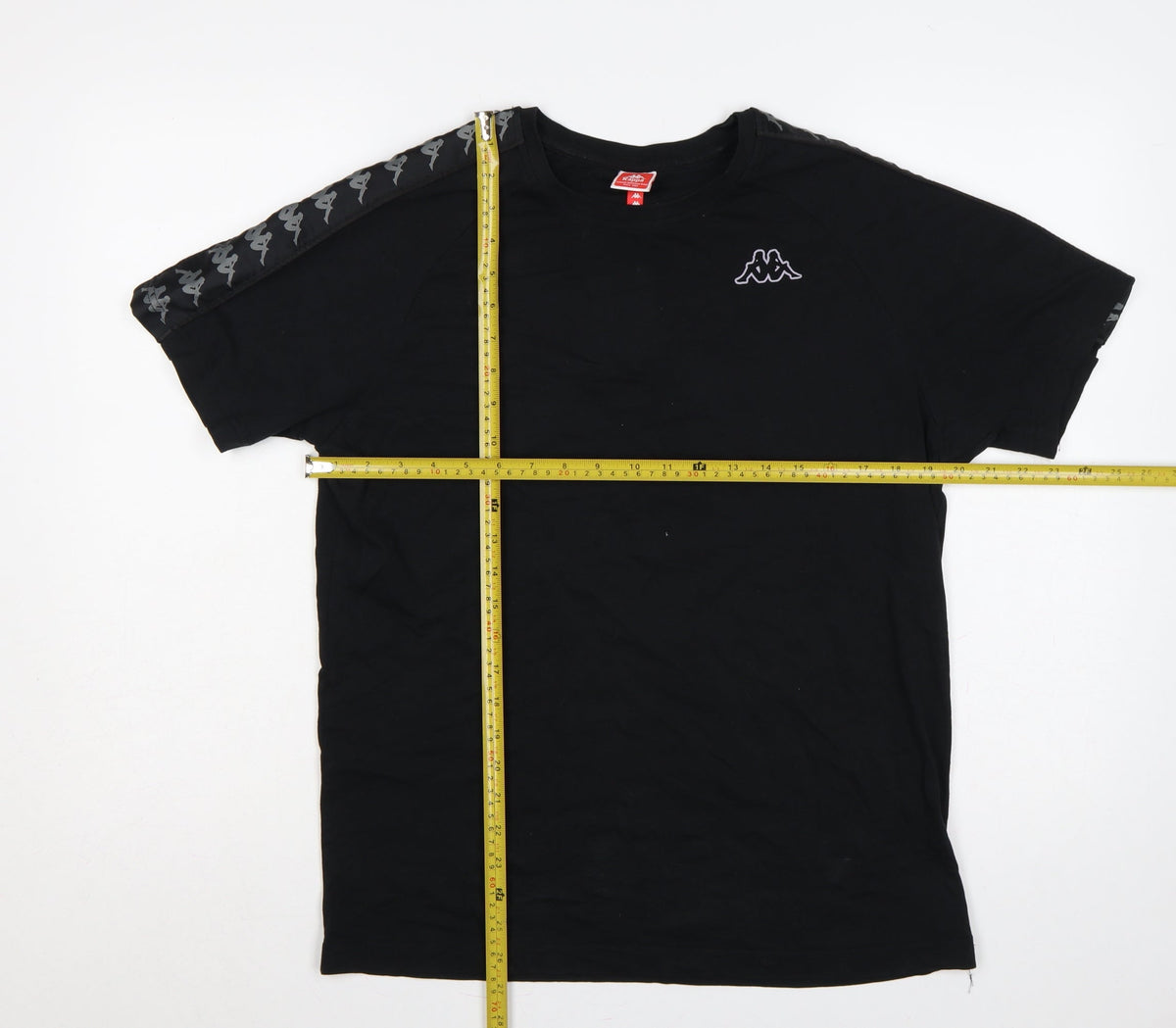 Close-up detail of Kappa men’s black large logo tape crew neck short sleeve t-shirt