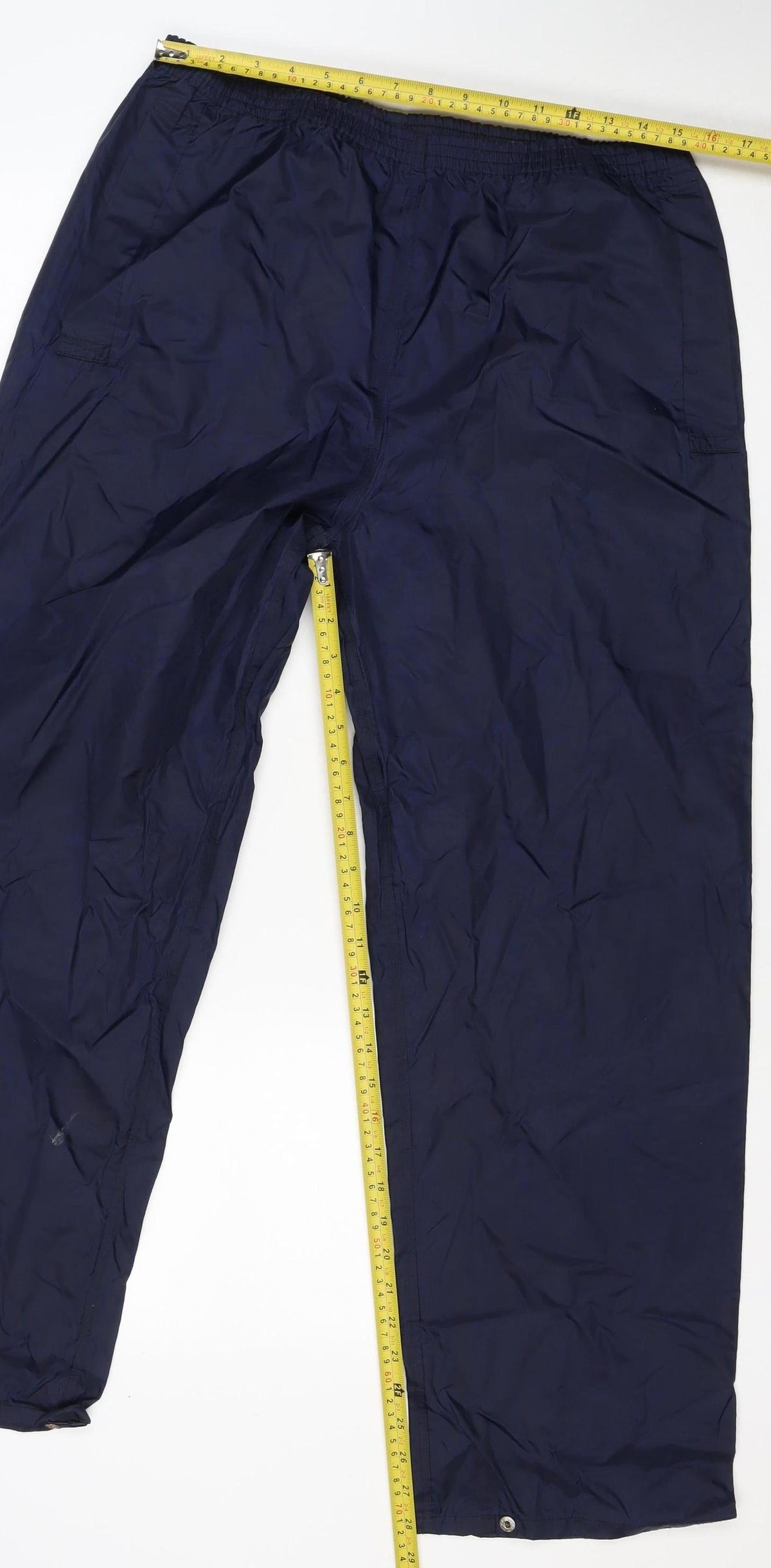 Brand and care label for Regatta Men's Blue S Waterproof Rain Trousers Elastic Waist Outdoor