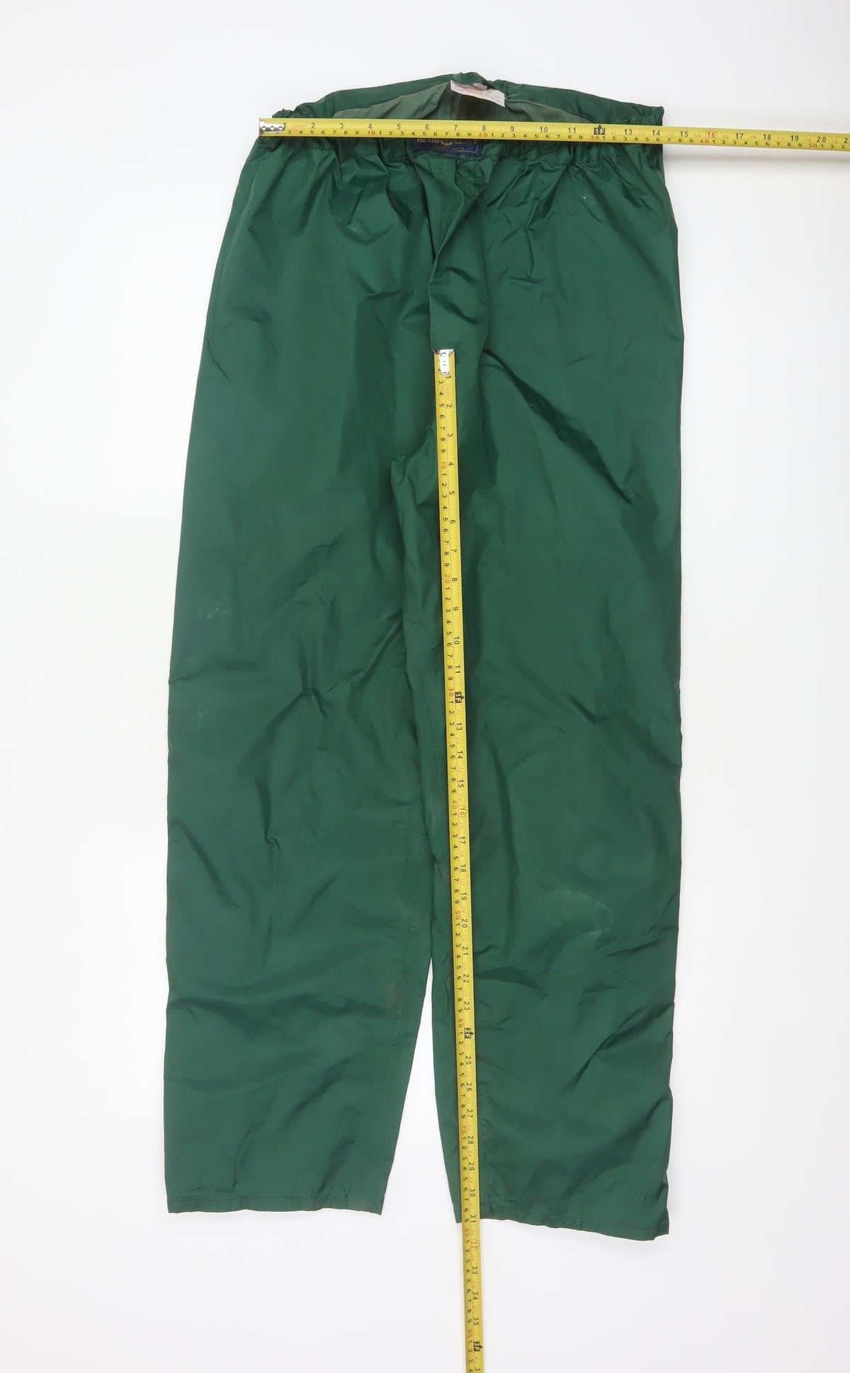 Close-up detail of Henri Lloyd Men’s Green, size S, Nylon Rain Trousers Ankle Zip Vintage