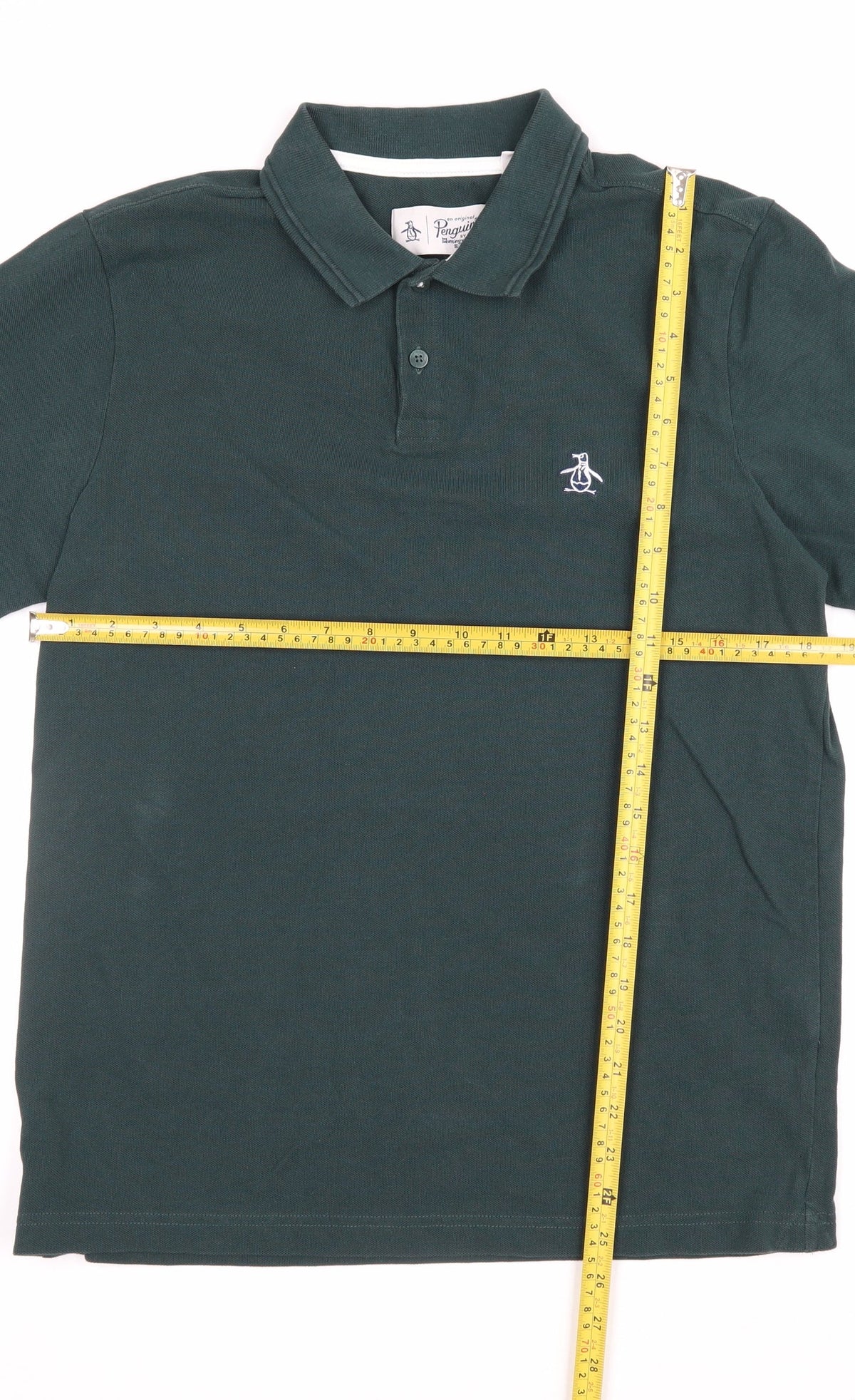 Close-up detail of Original Penguin men’s green m classic embroidered logo polo shirt