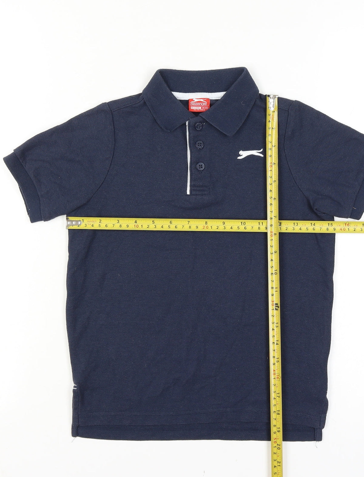 Close-up detail of Slazenger boys’ blue 9-10 years short sleeve logo polo shirt