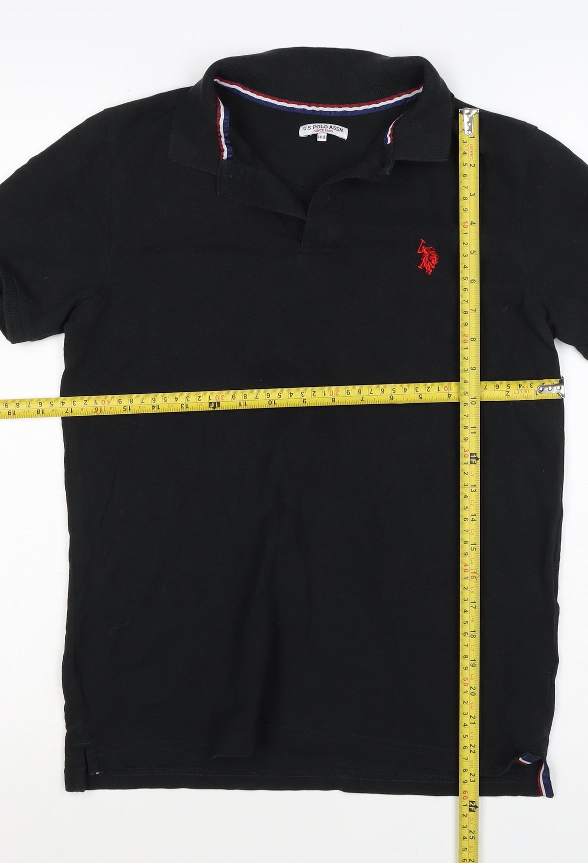Brand and care label for U.S. Polo Assn. boys’ black 14-15 years classic cotton polo shirt