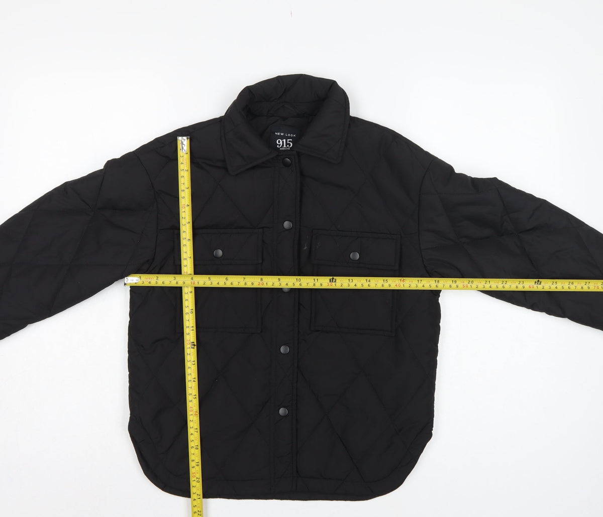 Close-up detail of New Look 915 girls’ black age 9 quilted shirt jacket padded